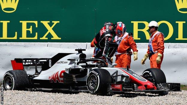 Romain Grosjean of Haas climbs out of his car after spinning during practice