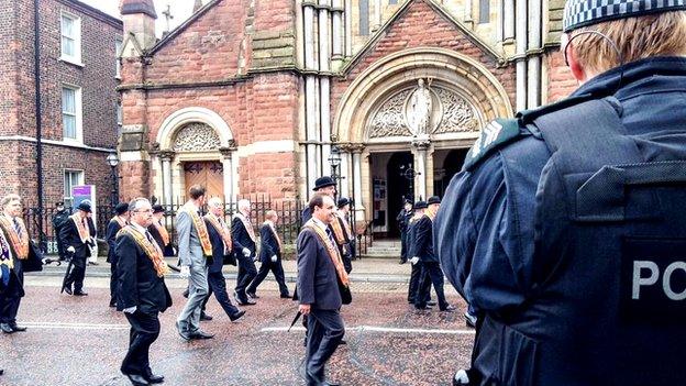 Orangemen pass St Patrick's Church in north Belfast