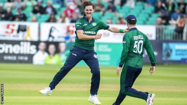 Mark Adair celebrates on his wickets with George Dockrell, who top-scored in New Zealand's innings with 74