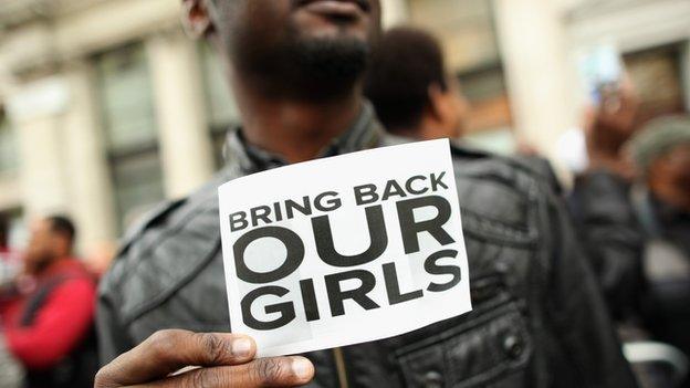 Protestor with a sign to save the schoolgirls