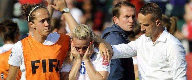 Mark Sampson (right) consoles Laura Bassett