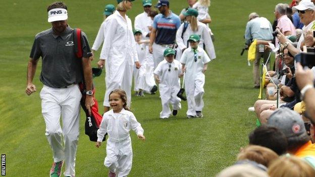 Bubba Watson running with his daughter