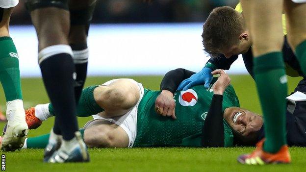 Keith Earls is attended to during the first half of Ireland's 32-20 defeat by England