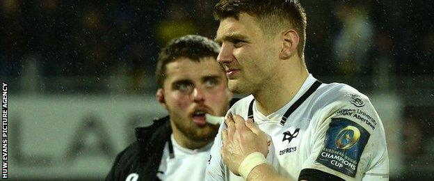 Dan Biggar holds his shoulder after being injured playing for Ospreys against Saracens