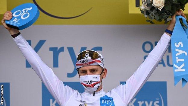 Tadej Pogacar holds his arms aloft in celebration after winning stage five of the 2021 Tour de France