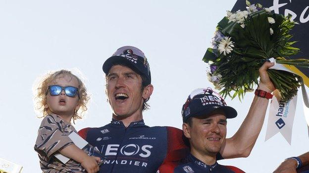 Geraint Thomas celebrates on the podium with his son Macsen