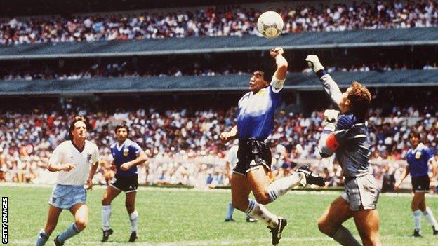 Diego Maradona scores against England using his hand