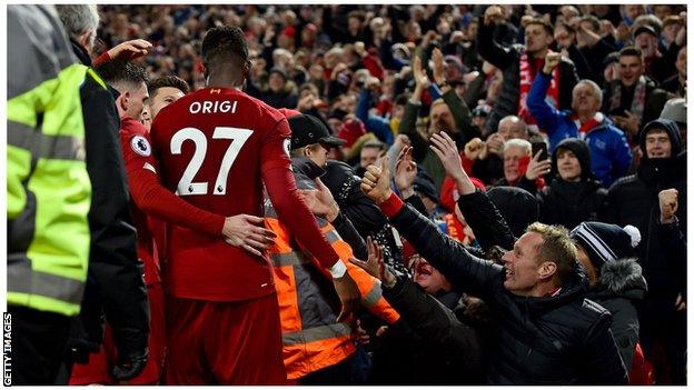 Origi celebrates with fans at Anfield, 2019.