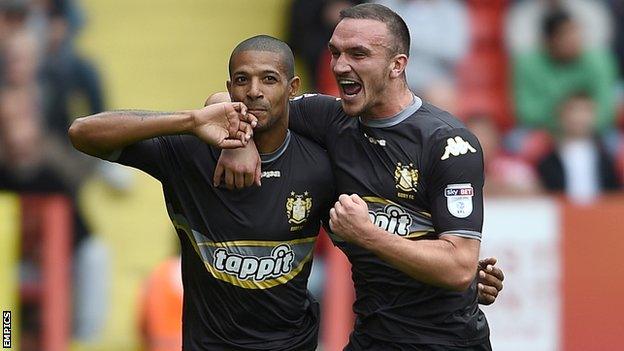 Jermaine Beckford celebrates scoring for Bury against Charlton Athletic