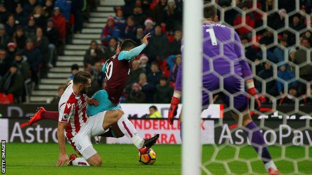 West Ham forward Manuel Lanzini falls over as he is tackled by Stoke defender Erik Pieters