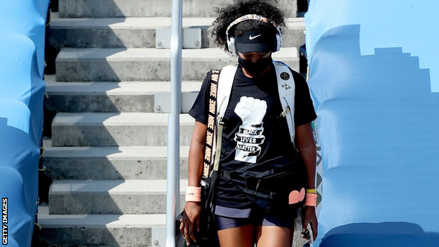 Naomi Osaka walks onto court wearing a Black Lives Matter t-shirt