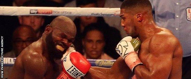 Anthony Joshua connects with a big right-hand punch on the chin of Carlos Takam