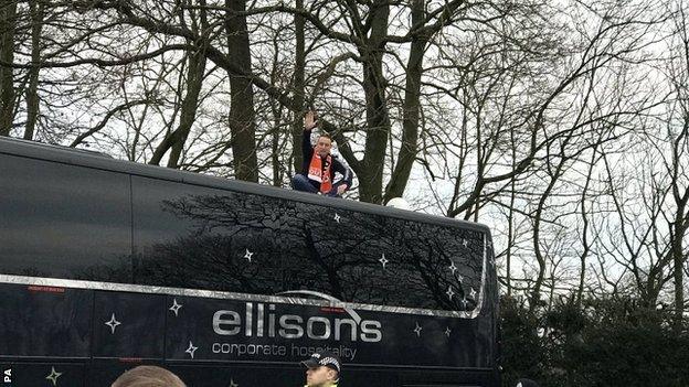 The Blackpool fan delayed the Arsenal coach leaving the team hotel by staging a protest on the roof