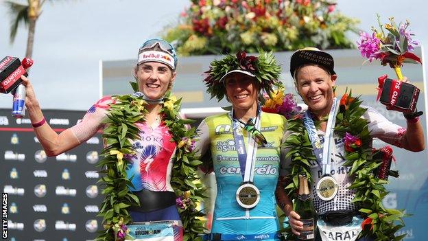 Ironman world champion Anna Haug, silver medallist Lucy Charles-Barclay and bronze medallist Sarah Crowley celebrate on the podium