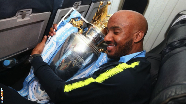 Fabian Delph hugs the Premier League trophy