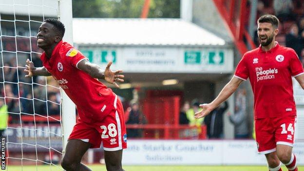 Panutche Camara (left) celebrates a goal for Crawley