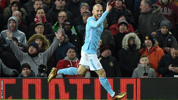 David Silva celebrates scoring the opener for Manchester City against Manchester United