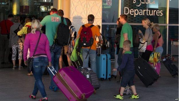 Tourists flock to Enfidha airport near Sousse on Saturday after holiday companies arranged extra flights to bring them home