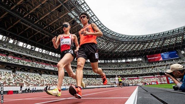 Japan's Hiroaki Kajisa and his guide runner