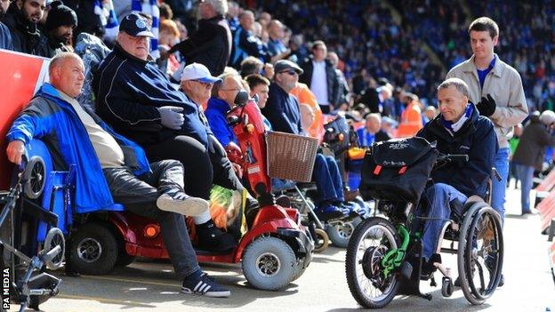 Wheelchair users attend a football match