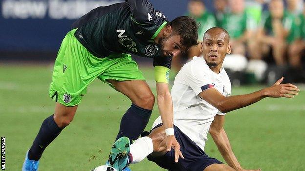 Bruno Fernandes (left) is tackled by Liverpool's Fabinho