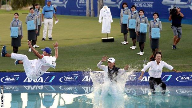 South Korea's Jin Young Ko (centre), her caddie and agent jump in Poppie's Pond in 2019