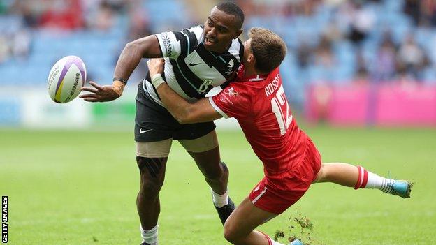 Waisea Nacuqu of Team Fiji is tackled by Ewan Rosser of Team Wales