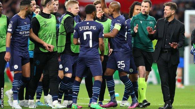 Man City players and Diego Simeone (right)