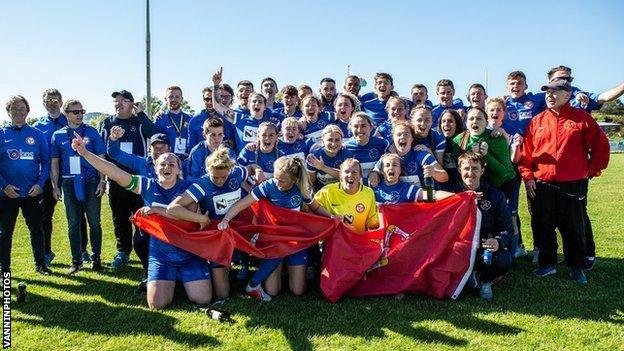 The Isle of Man women's football team celebrate their gold medal with the rest of the team