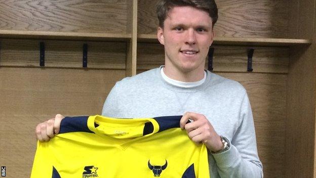 Rob Dickie holds up an Oxford United shirt