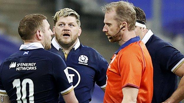 Scotland's Finn Russell pleads his case with referee Wayne Barnes before being sent off against France