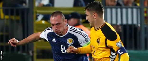 Scotland's Scott Brown challenges Lithuania's Fedor Chernykh