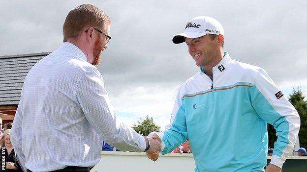 Michael Hoey shakes hands with Stormont Minister Simon Hamilton at the opening of Galgorm Castle's new Fun Golf area on Wednesday