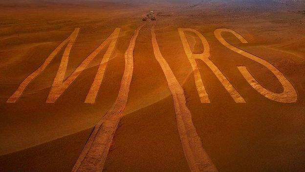 An artist's drawing of a Mars rover writing "Mars" on the planet's surface.