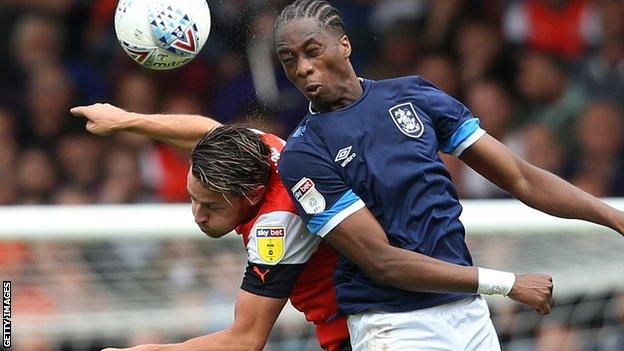 Terence Kongolo wins a header