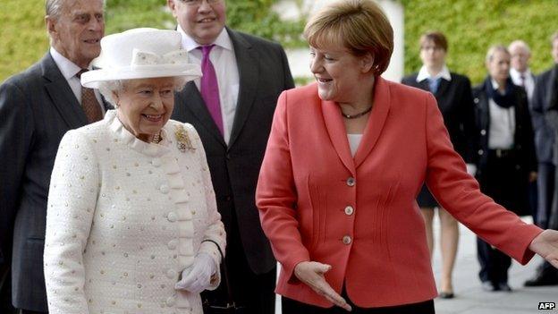 German Chancellor Angela Merkel shows the way to Queen Elizabeth II upon her arrival at the Chancellery in Berlin on 24 June 2015