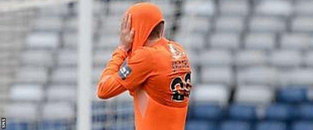 Blair Spittal puts his head inside his jersey after defeat in the penalty shoot-out