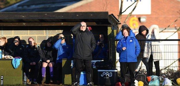 Neil Redfearn shields his eyes from the sun as he overlooks his first game in charge of Doncaster Rovers Belles in WSL 2