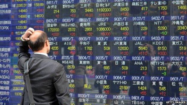 A Japanese man looking at Japan's stock market figures