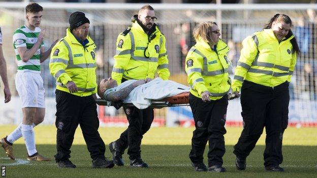 Jonny Hayes is carried off on a stretcher