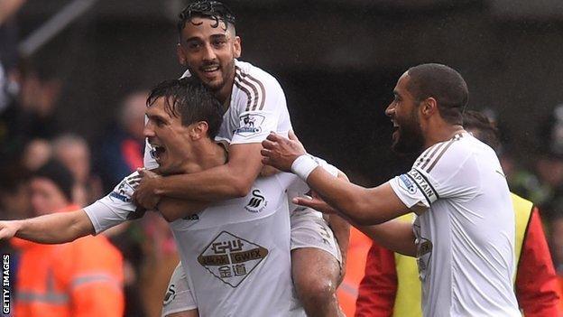 Jack Cork, Neil Taylor and Ashley Williams celebrate a Swansea goal