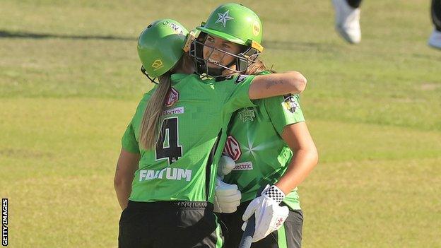 Tess Flintoff of the Stars is congratulated by Nicole Faltum of the Stars after hitting fifty