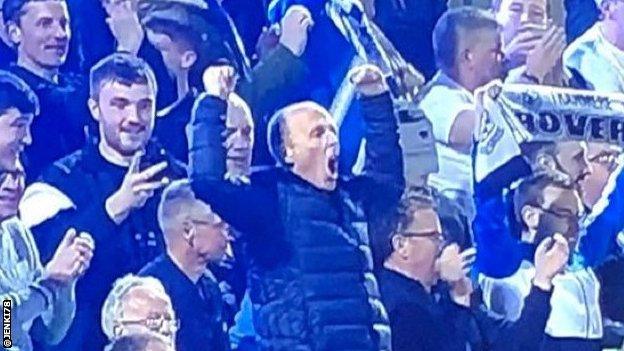 Referee Mike Dean celebrating.