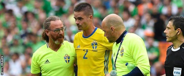 Sweden's medical team escort Mikael Lustig off the field in France