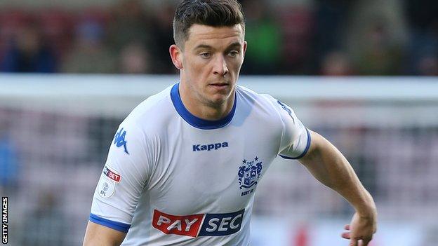 Callum Reilly in action for Bury