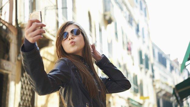 Girl taking a selfie with her mobile phone