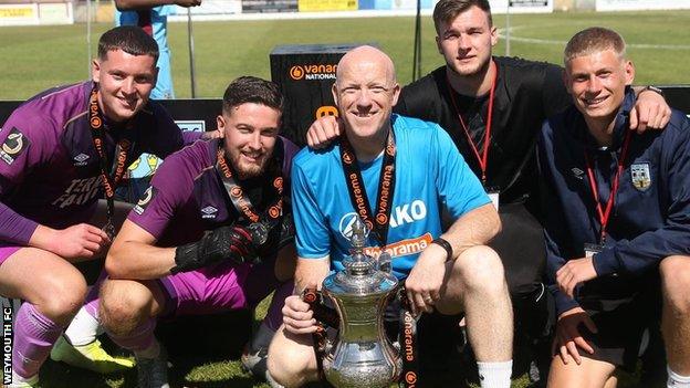 Robbie Yates pictured with Weymouth players after winning the National League South Promotion final