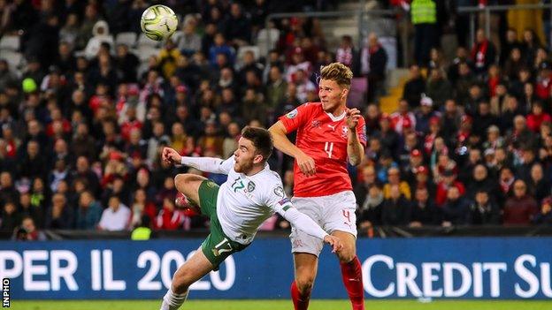 Aaron Connolly battles with Switzerland's Nico Elvedi