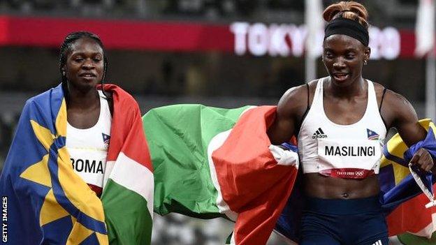 Second-placed Namibia's Christine Mboma (L) and Namibia's Beatrice Masilingi react after the women's 200m final during the Tokyo 2020 Olympic Games at the Olympic Stadium in Tokyo on August 3, 2021.