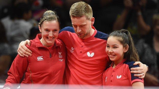 Hursey, right, celebrates with coach Stephen Jenkins and teammate Chloe Thomas Wu Zhang, left.